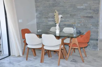a dining room with a glass table and chairs at Miramar Prestigia in Ville Nouvelle