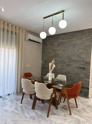 a dining room with a glass table and chairs at Miramar Prestigia in Ville Nouvelle