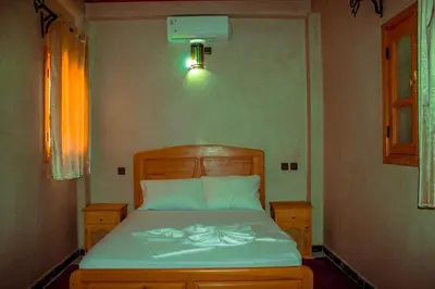 a bedroom with a bed in a room at Riad Restaurant MARZOUK in Aït Baha