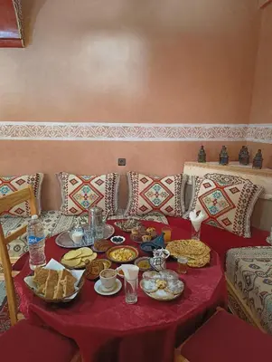 a table with plates of food on top at Riad Restaurant MARZOUK in Aït Baha