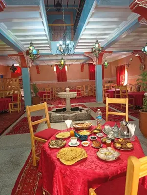 a table with food on it in a room at Riad Restaurant MARZOUK in Aït Baha