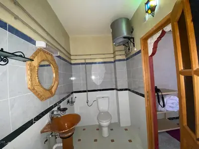 a small bathroom with a toilet and a sink at Riad Restaurant MARZOUK in Aït Baha
