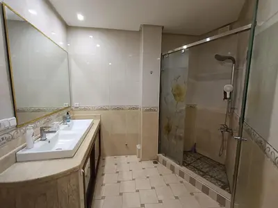a bathroom with a sink and a shower at Appartement a Meknès-Hamria in Meknès
