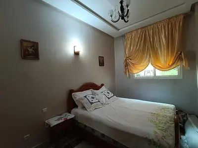 a small bedroom with a bed and a window at Appartement a Meknès-Hamria in Meknès