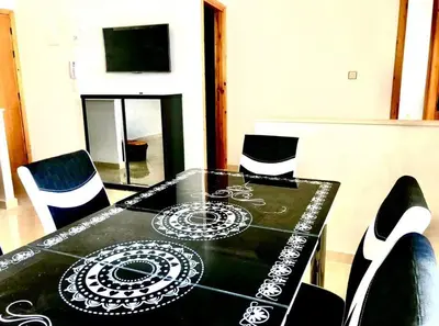 a dining room table with a black and white pattern on it at Modern apartment Hamria Meknes in Meknès