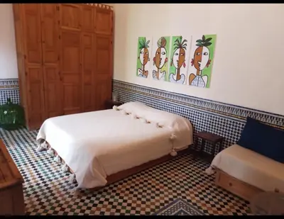 a bedroom with a bed in a room at زاوية السعادة in Fès