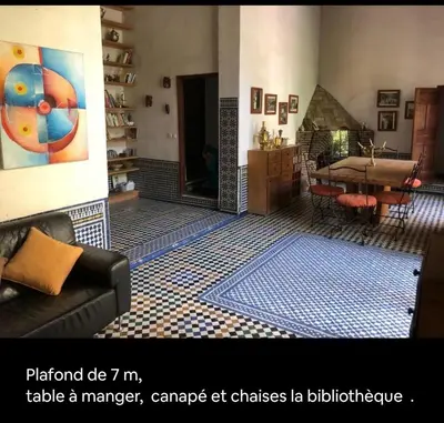 a living room with a fireplace and a table at زاوية السعادة in Fès