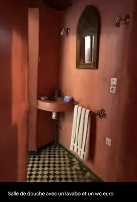 a bathroom with a sink and a mirror at زاوية السعادة in Fès