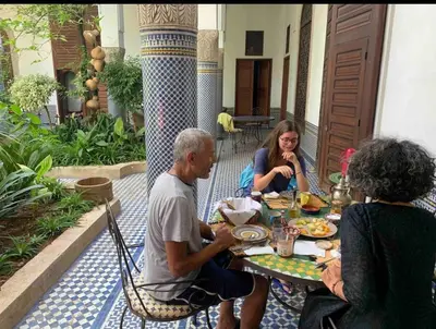 a group of people sitting at a table eating food at زاوية السعادة in Fès