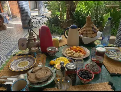 a table with plates of food on top at زاوية السعادة in Fès