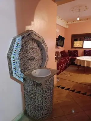 a bathroom with a sink in the corner of a room at Tradionelle Berber Ain Sardoun in Beni Mellal