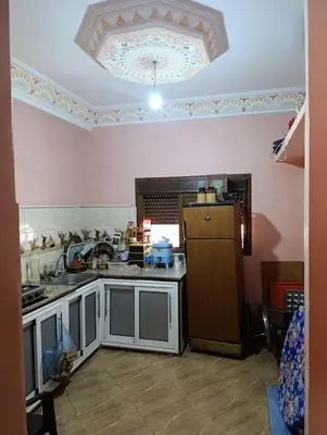 a kitchen with a sink and a refrigerator at Tradionelle Berber Ain Sardoun in Beni Mellal
