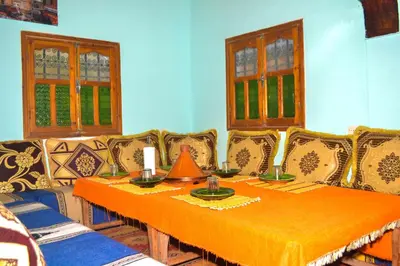 a dining room with a table and chairs at Kasbah Les Nomades in Skoura