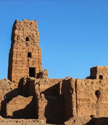 an old brick building with a blue sky in the background at Dâr Mâbâ in Tazenakht