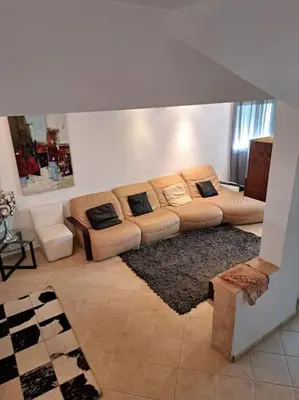 a living room with a couch with pillows on it at Chalet Villa de Luxe - Piscine in Dchar Aït Belkassem