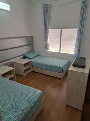 a room with three beds and two windows at Chalet Villa de Luxe - Piscine in Dchar Aït Belkassem
