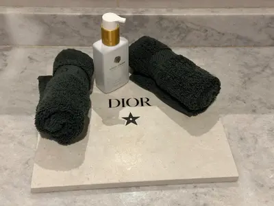 two slippers and a bottle of dir on a counter at Villa de standing piscine à débordement à 15 min de Marrakech in Ourika