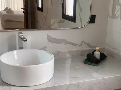 a bathroom with a large white tub on a counter at Villa de standing piscine à débordement à 15 min de Marrakech in Ourika