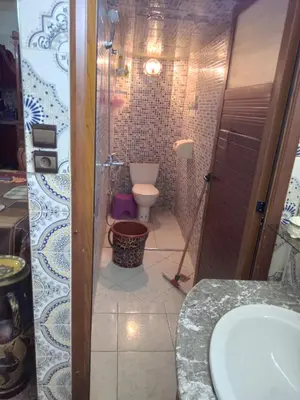 a bathroom with a toilet and a shower and a sink at إقامة شاكر in Meknès