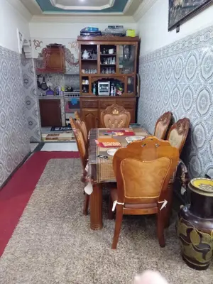 a dining room with a table and some chairs at إقامة شاكر in Meknès