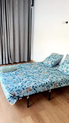a bed in a room with a blue sheet on it at Domaine Farah in Meknès