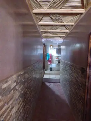 a hallway in a building with a wooden ceiling at gîte taghia ahansal in Taghia