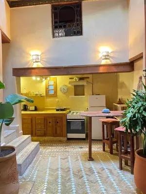 a kitchen with a table and a counter top at Dar Fes Zahra in Fès