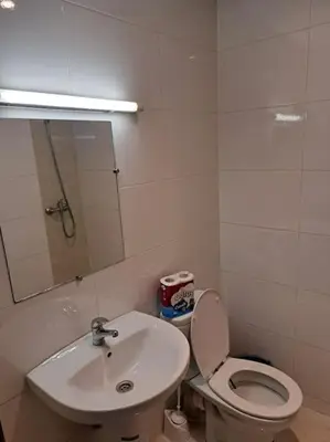 a bathroom with a sink and a toilet and a mirror at Appartement Centre Ville - ATLAS 46 in Fès