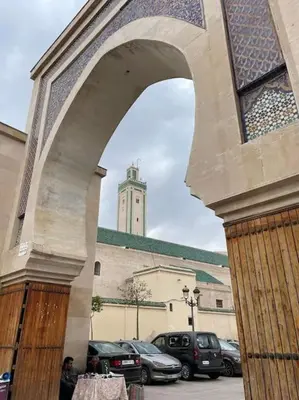 a building with a clock tower in the background at Appartement Centre Ville - ATLAS 46 in Fès