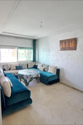 a living room with blue couches and a table at Appartement Centre Ville - ATLAS 46 in Fès