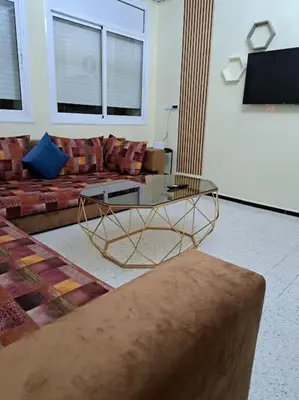 a living room with a couch and a coffee table at Appartement Atlas City Center 2 in Fès