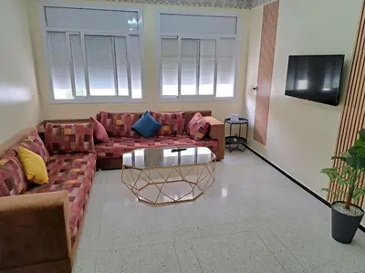 a living room with a couch and a table at Appartement Atlas City Center 2 in Fès