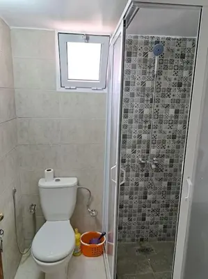 a small bathroom with a toilet and a shower at Appartement Atlas City Center 2 in Fès