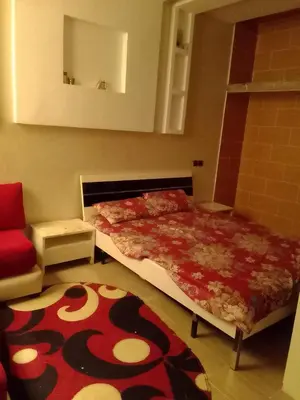 a bedroom with a bed and a red carpet at Tifelt in Tiflet