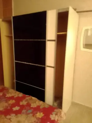 a bedroom with a dresser and a closet at Tifelt in Tiflet