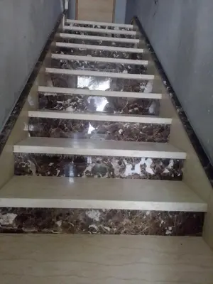 a set of stairs in a building with marble at Tifelt in Tiflet