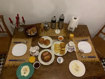 a wooden table with plates of food on it at Appartement khmissa in Fès al Bali