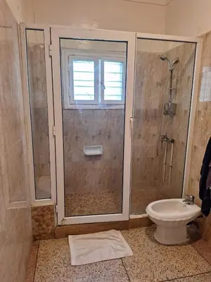 a bathroom with a shower and a toilet at Fes City Center Comfy Apartment in Fès