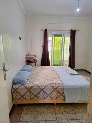 a bedroom with a large bed and a window at Fes City Center Comfy Apartment in Fès