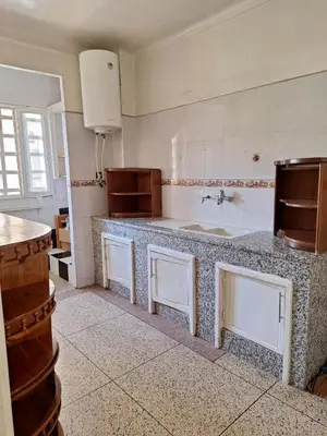 a kitchen with a counter and a sink in it at Fes City Center Comfy Apartment in Fès