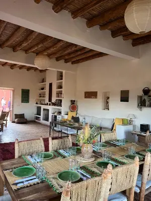 a living room with a table and a couch at Dar Tasmayoun in Aït Ourir
