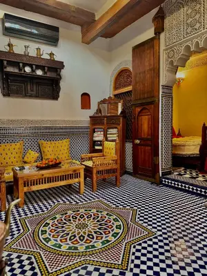 a living room with a couch and a table at Dar Tagore in Fès