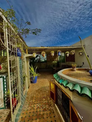 an outdoor patio with a tiled floor and a building at Dar Tagore in Fès