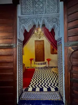 an entrance to a room with a blue and white tile floor at Dar Tagore in Fès