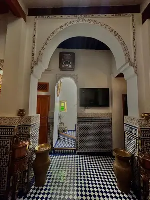 an archway in a room with a tiled floor at Dar Tagore in Fès