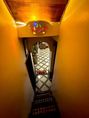an overhead view of a stairway with a stained glass window at Riad Phœnix in Fès al Bali