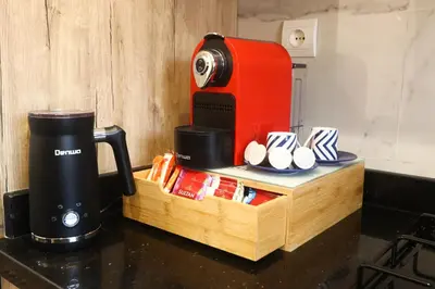 a coffee maker sitting on top of a counter next to a table at Dar Ibn Majdoub Prive Entier in Fès