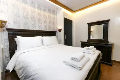 a bedroom with a large white bed with towels on it at Dar Ibn Majdoub Prive Entier in Fès