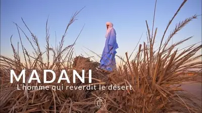 a woman standing on top of some tall grass at Oasis source de vie in Mhamid