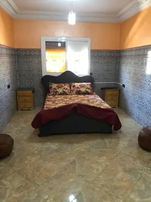 a bedroom with a large bed in a room at Mahmoud moulay Yacoub 1 in Moulay Yacoub